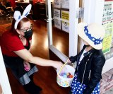 A local youngster visits a downtown merchant for Easter.